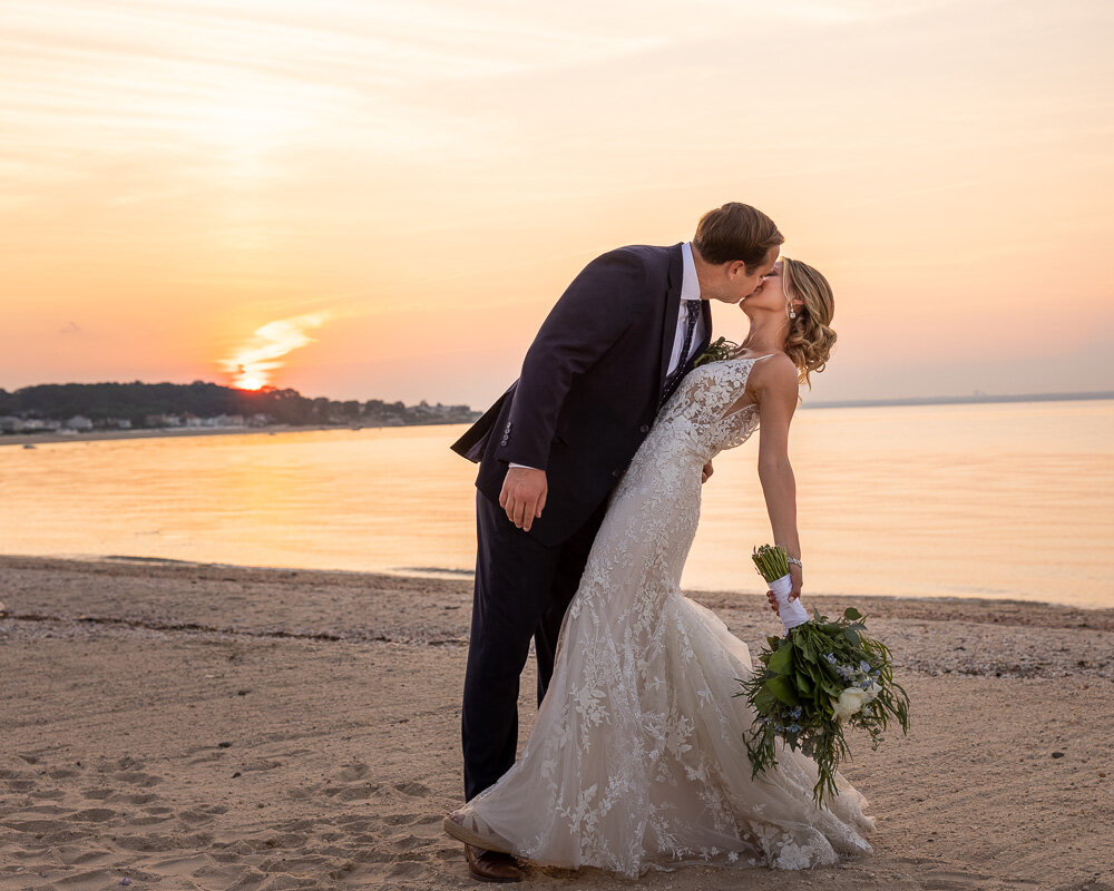 Couple enjoys moment together on the beach after getting married.