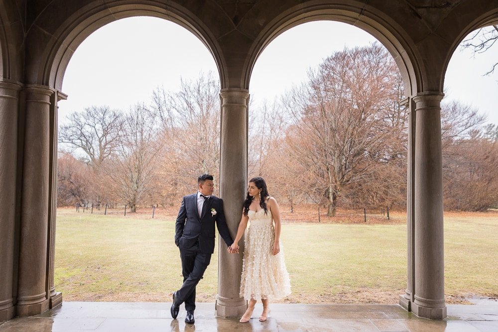 Couple shares glances at each other under the arches at Planting Fields.