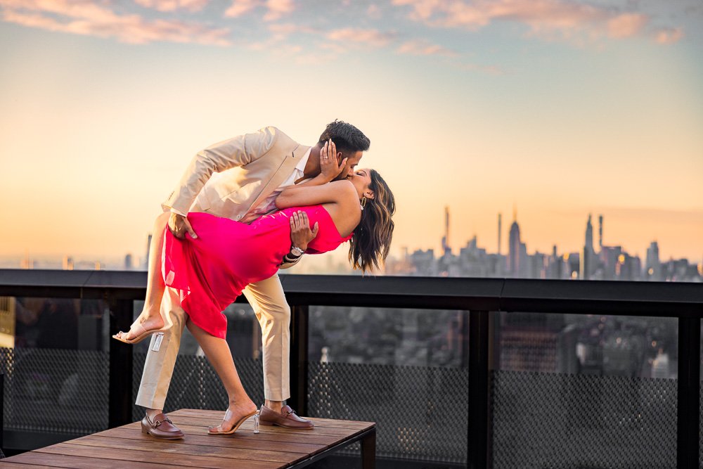 couple proposal rooftop new york city engagement photographer. Their engagement session outfits were a hot pink 