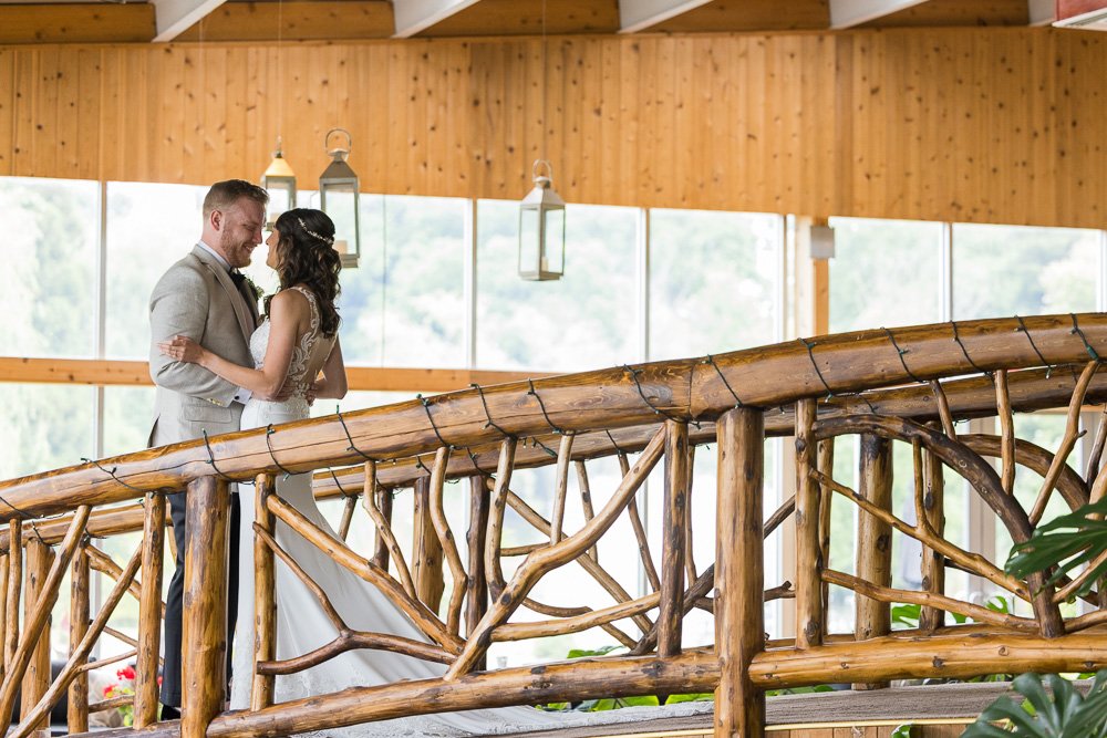 Couple shares a moment together on a bridge.