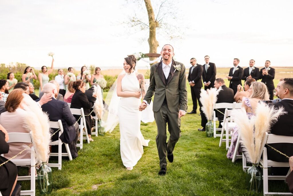 bride and groom walking down aisle after ceremony at Mansion at West Sayville