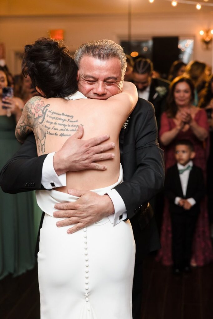 bride hugging father on dance foor