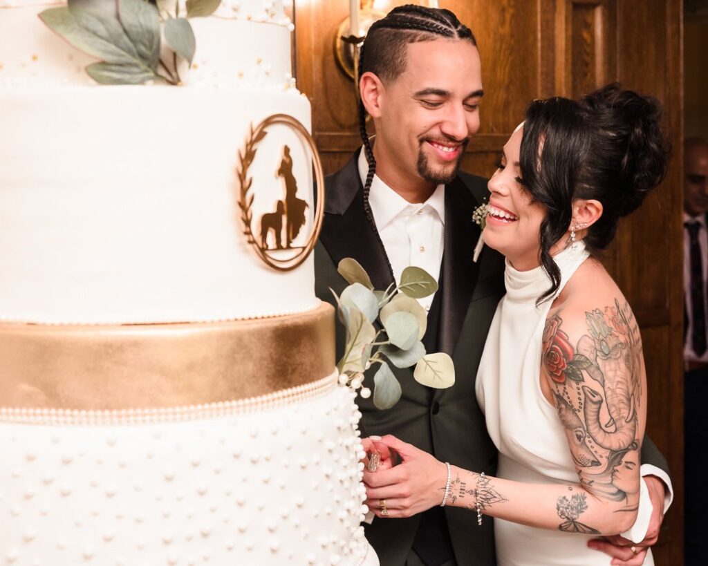 Long Island bride and groom cutting large cake at Mansion at West Sayville