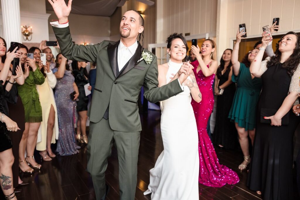 bride and groom walking into reception at Mansion at West Sayville