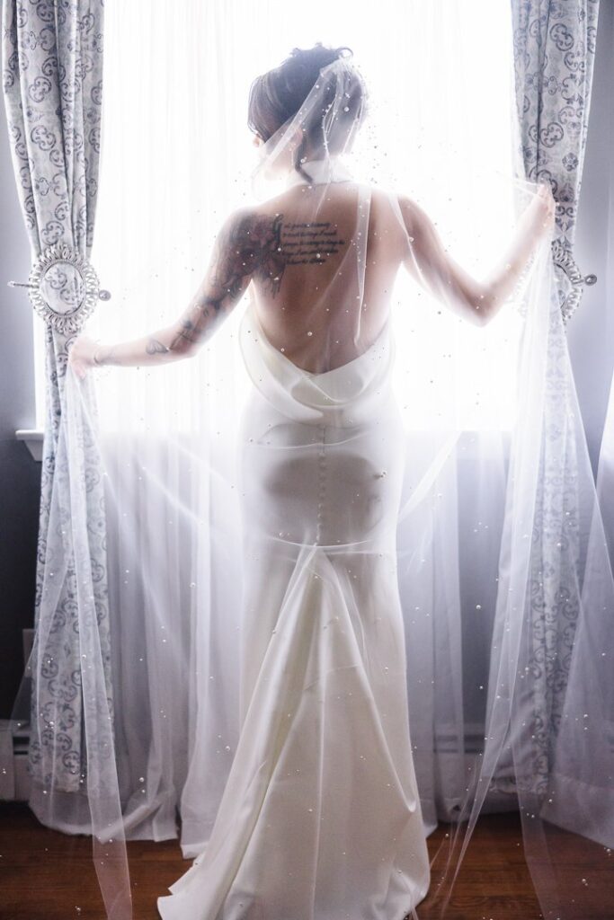 bride and back of dress looking out window