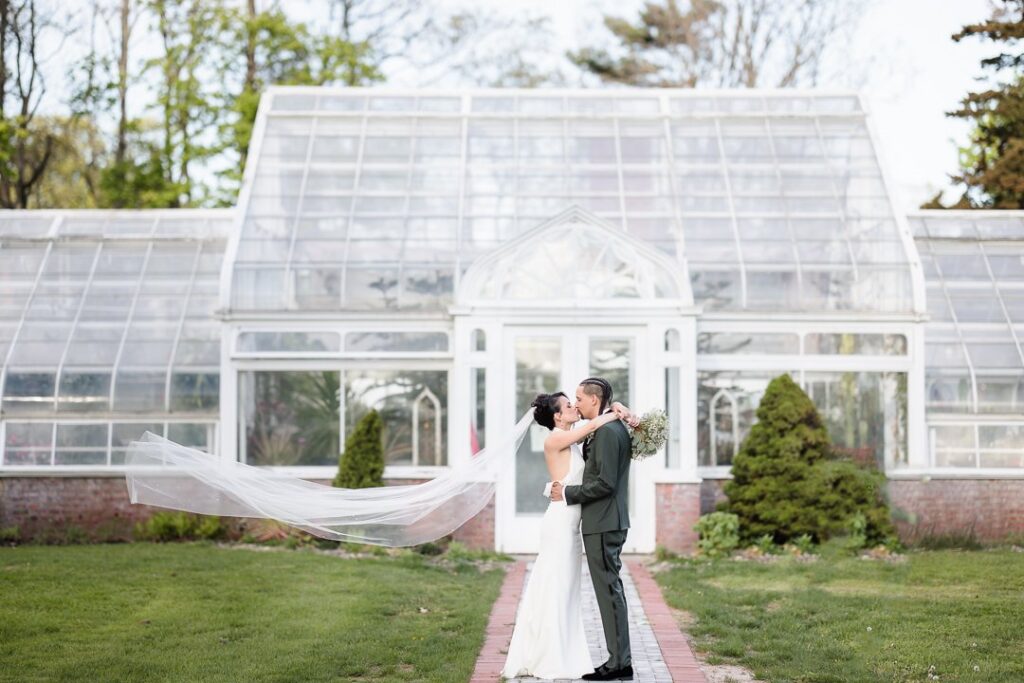 Newlyweds enjoy a moment together in front of the Bayview Room.