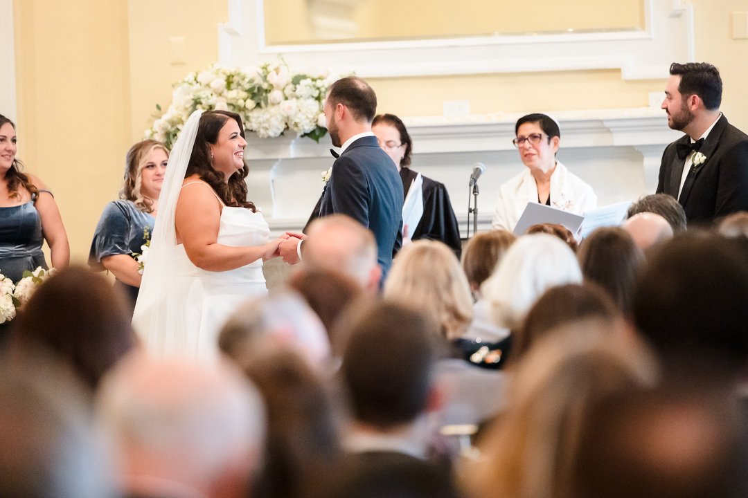 bride groom looking at each other indoor ceremony at Heritage Club Bethpage