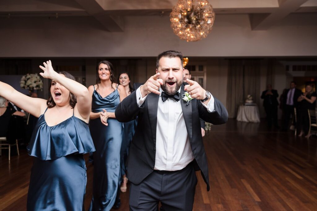 bridal party celebrating entering ballroom at heritage club reception