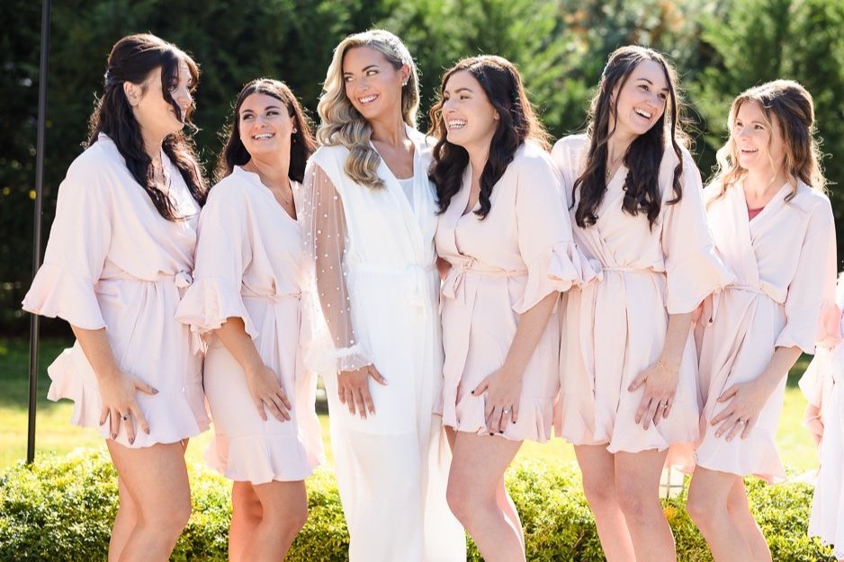 bride and bridesmaids celebrating while getting ready