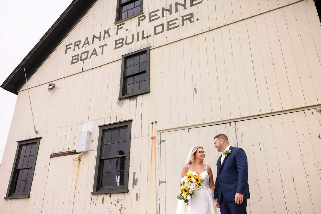 bride groom in front of barn Mansion at West Sayville