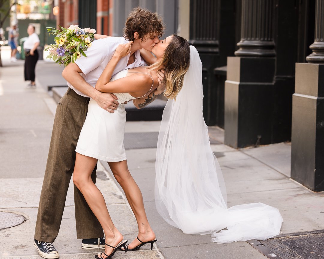 bride and groom kissing on Manhattan street