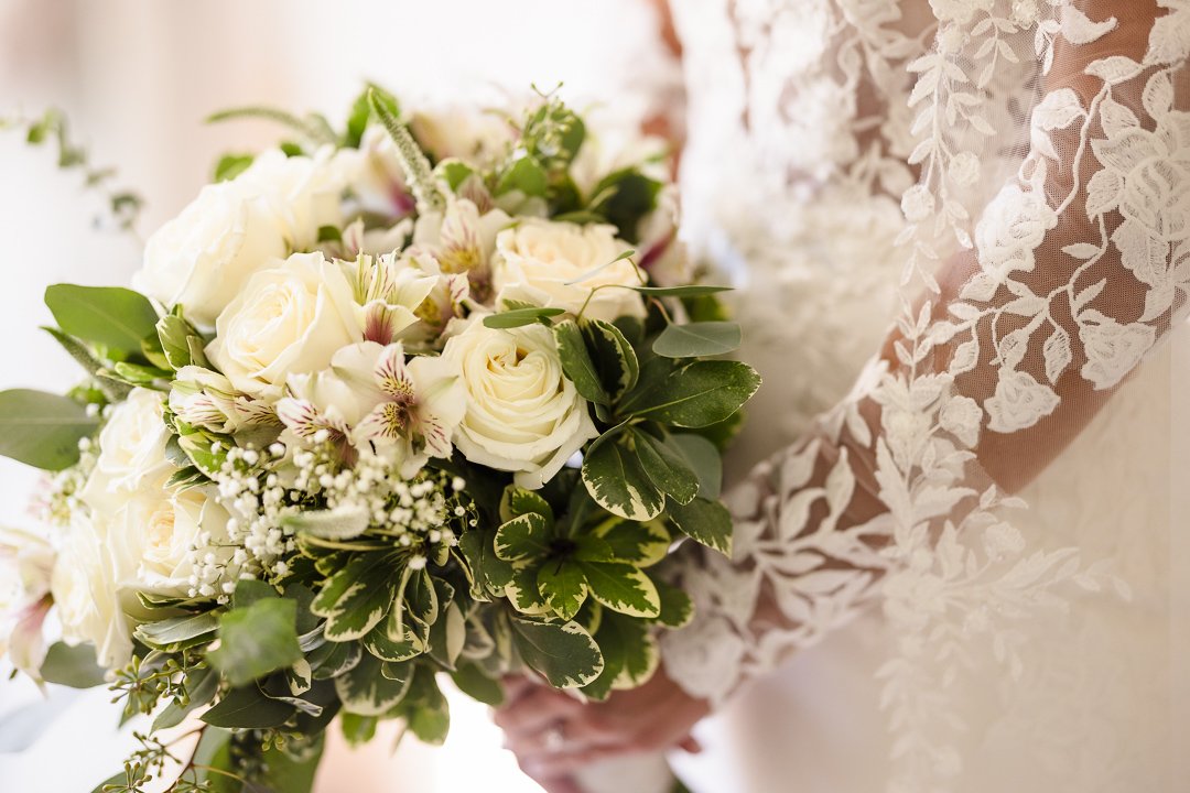 bride holding simple white bouquet