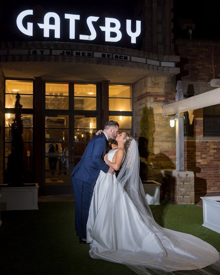 bride groom in front of Gatsby sign at Gatsby On The Ocean