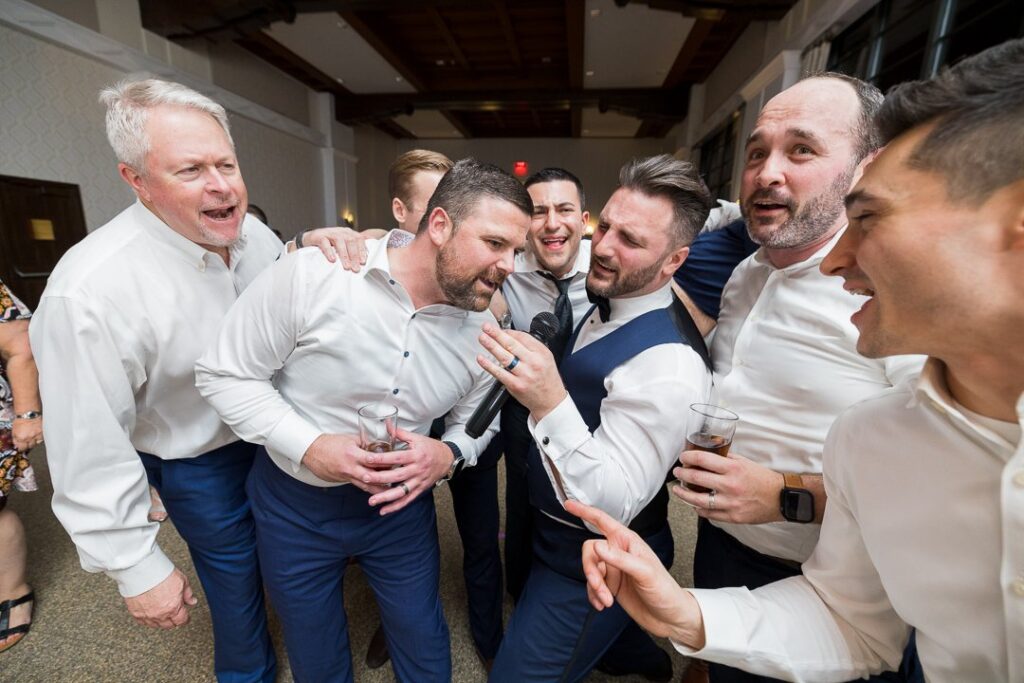 groom and groomsmen singing at Gatsby On The Ocean