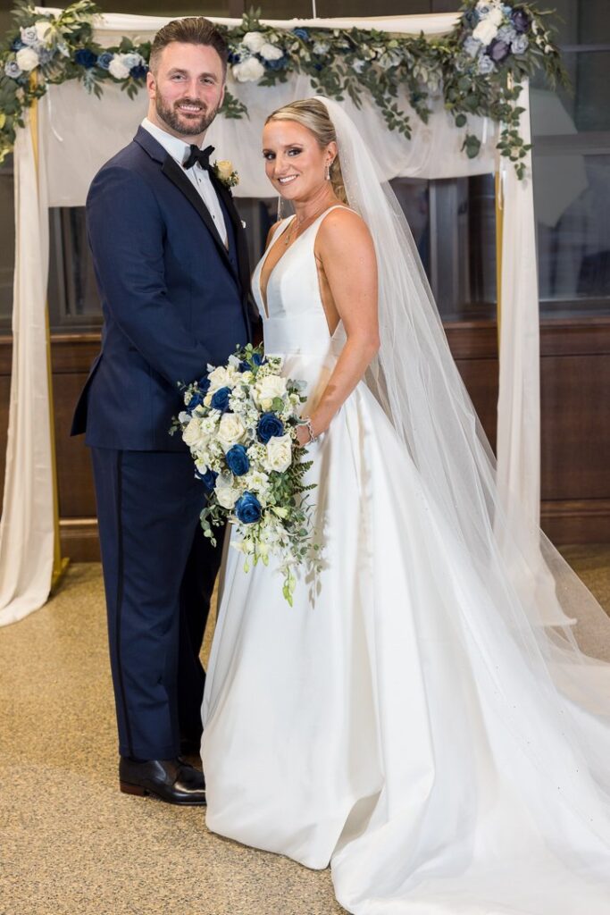 bride groom flower arch portrait at Gatsby On The Ocean