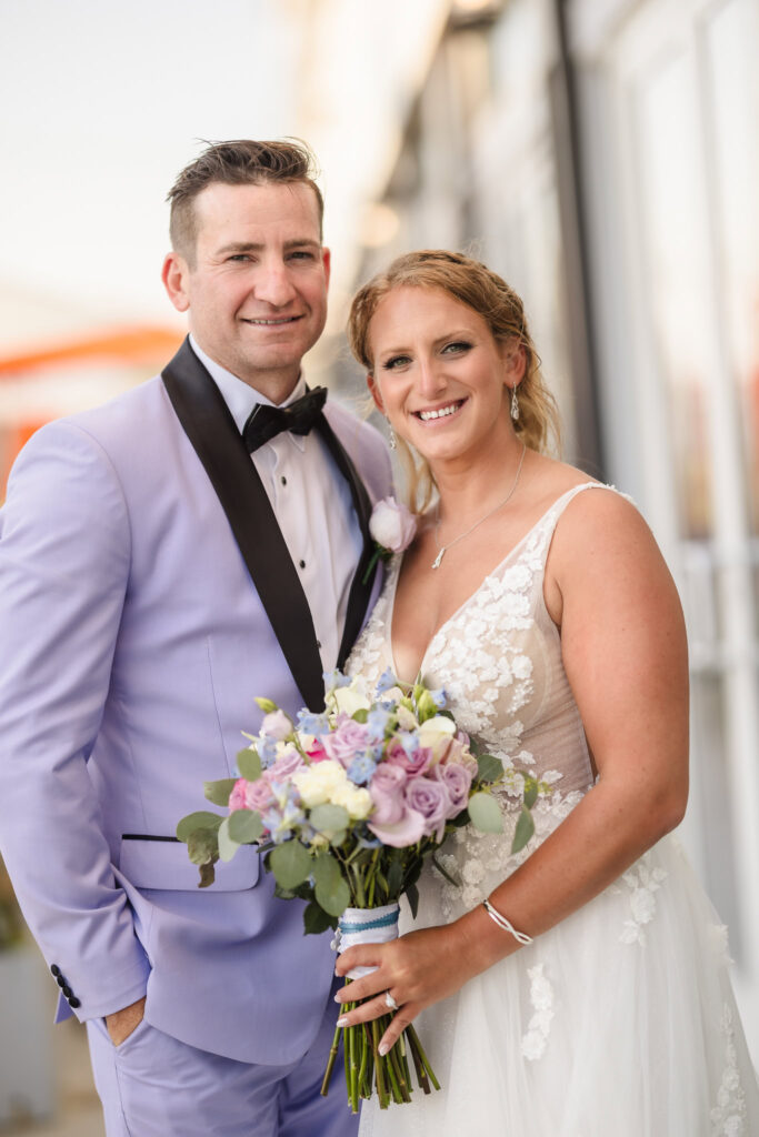 Bride and groom smiling and looking at the camera.