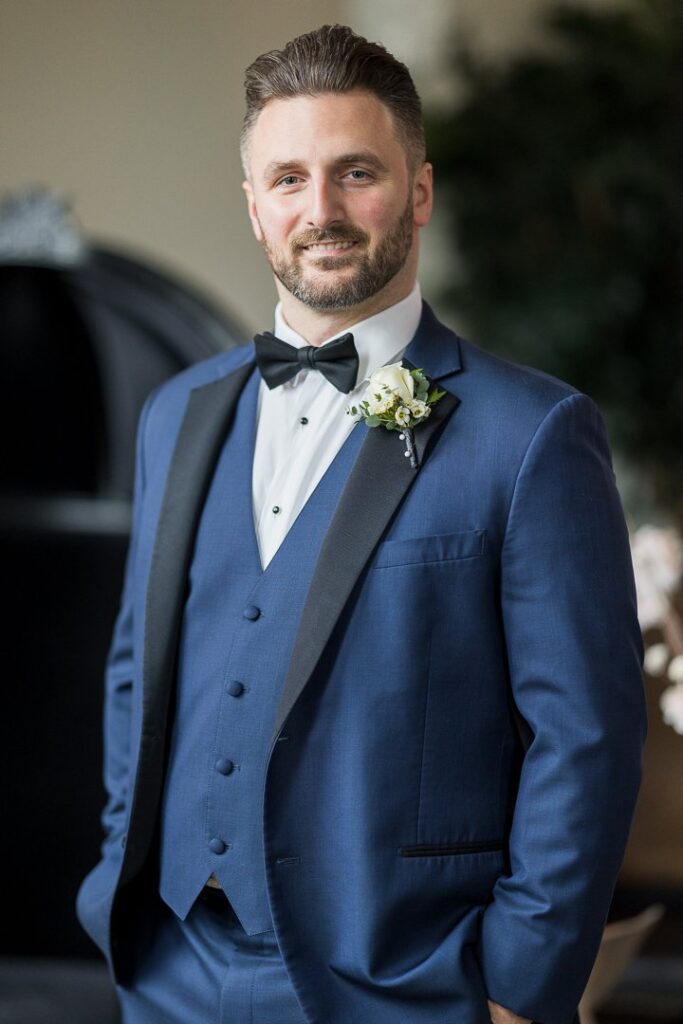 Groom in bridal suite looking at the camera at Gatsby on the Ocean