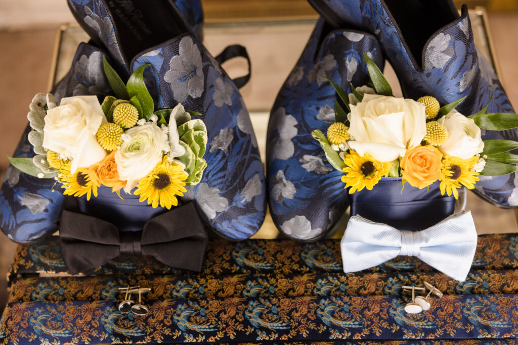 Shows, ties, and flowers of two grooms before they put them on.