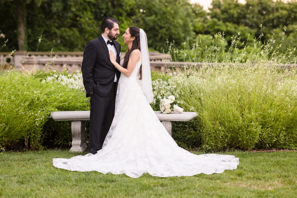 bride and groom looking at each other in the garden of Hempstead House at Sands Point Preserve