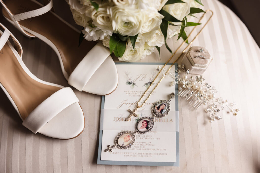 flat lay of shoes, bouquet, and wedding invitation