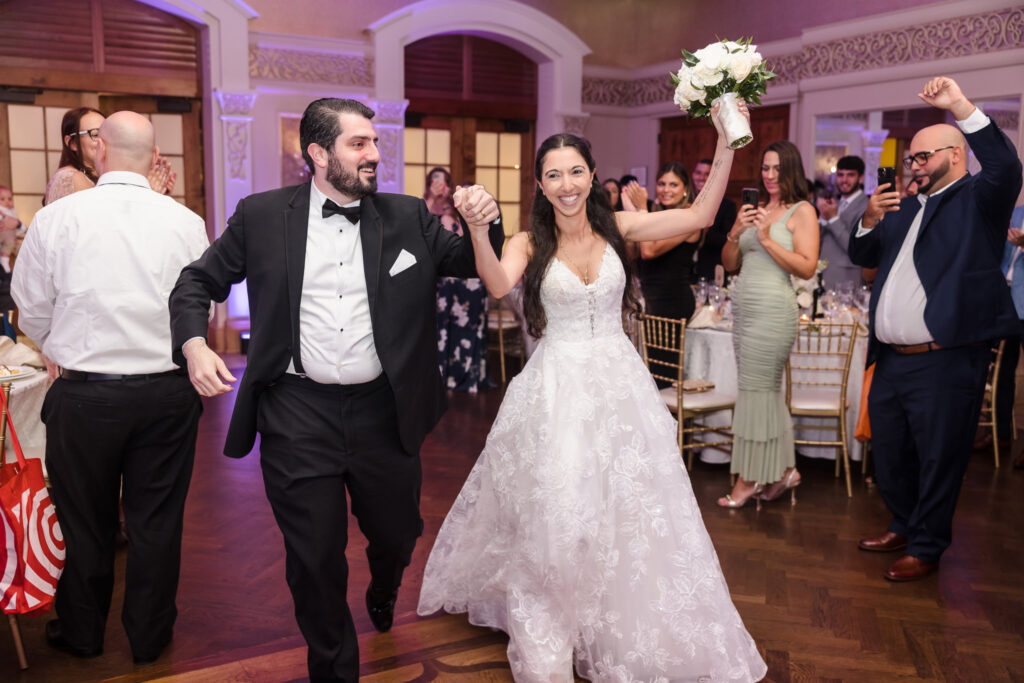 Bride and groom entering wedding reception at Larkfield