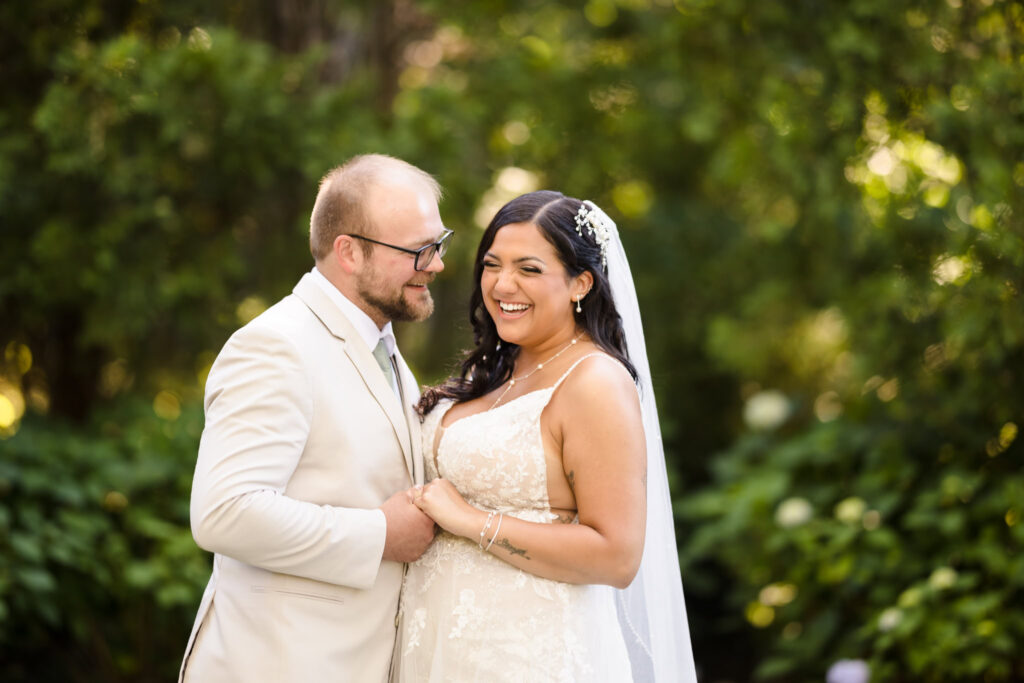 Bride and groom laughing with each other at Majestic Gardens.