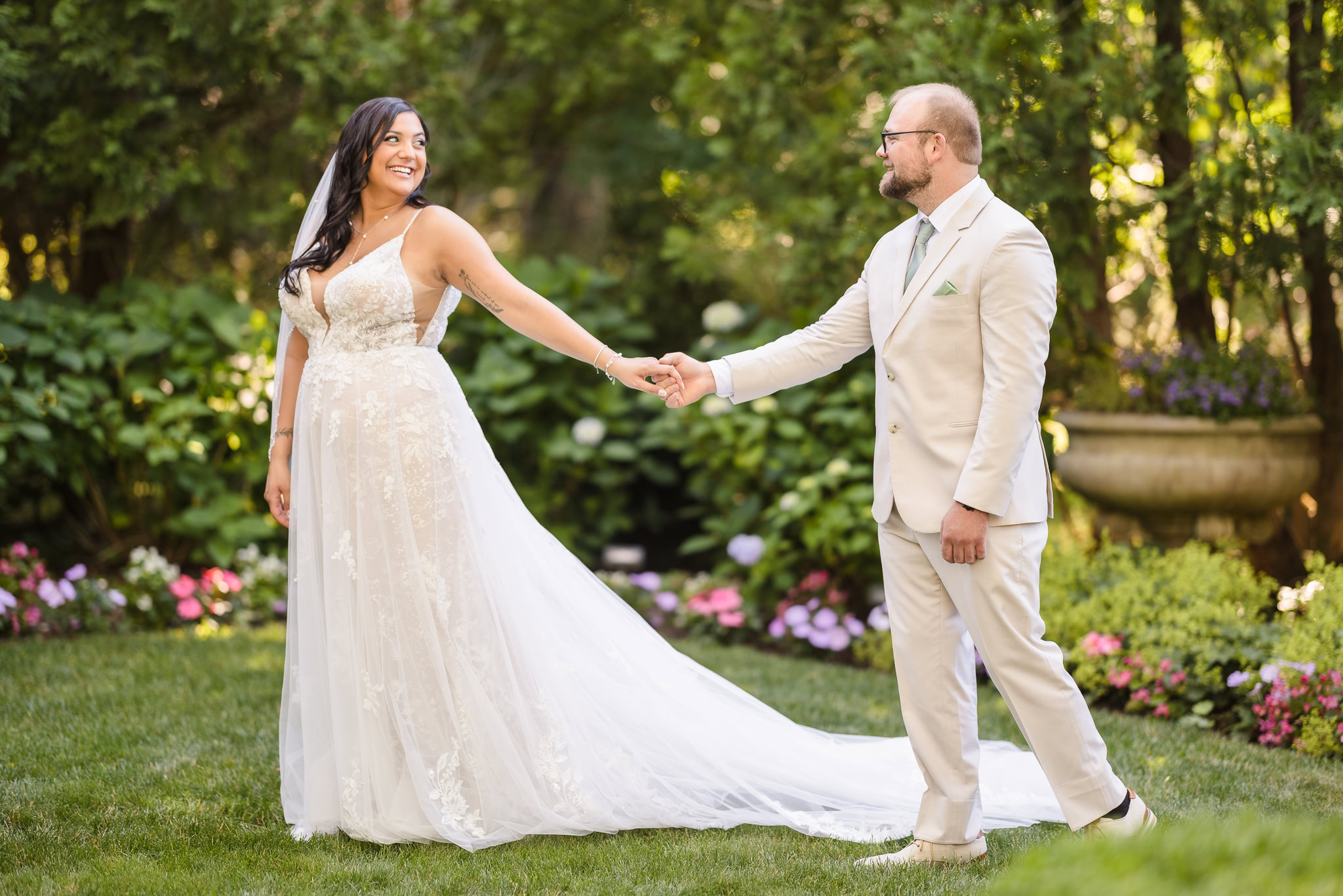 Bride leading groom through garden at Majestic Gardens Long Island wedding venue