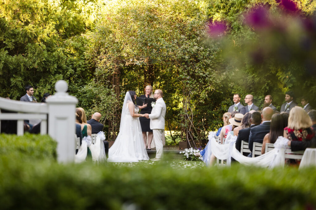 Bride and groom during ceremony at Majestic Gardens.