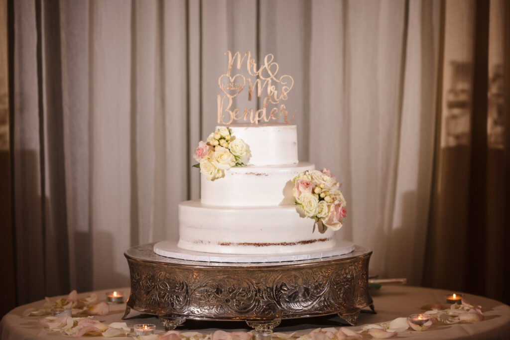 Wedding cake with three layers and flowers.