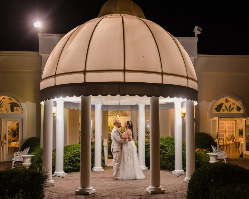 Couple under gazebo at night at Majestic Gardens.