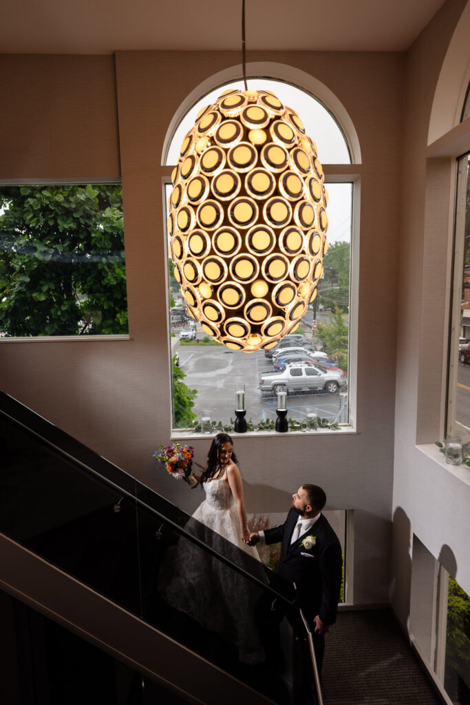 Bride and groom sharing a quiet moment on the staircase at Harbor Club at Prime on Long Island.