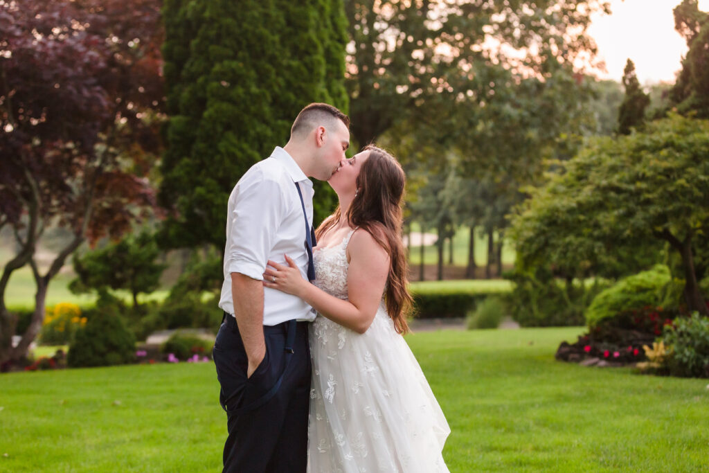 Bride and groom kissing during sunset at Rock Hill Country Club.