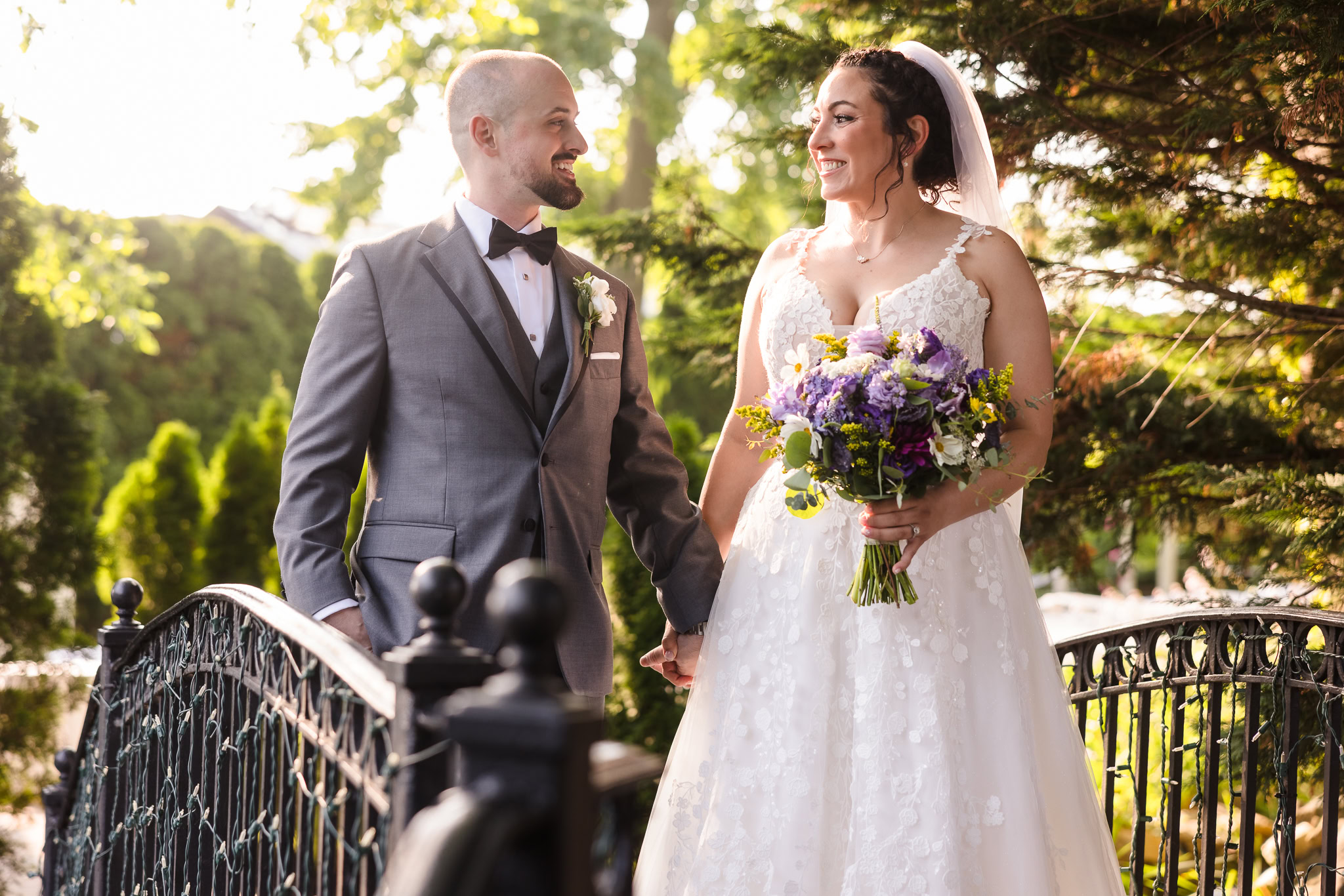 Bride and groom on bridge at The Somerly looking at each other and smiling