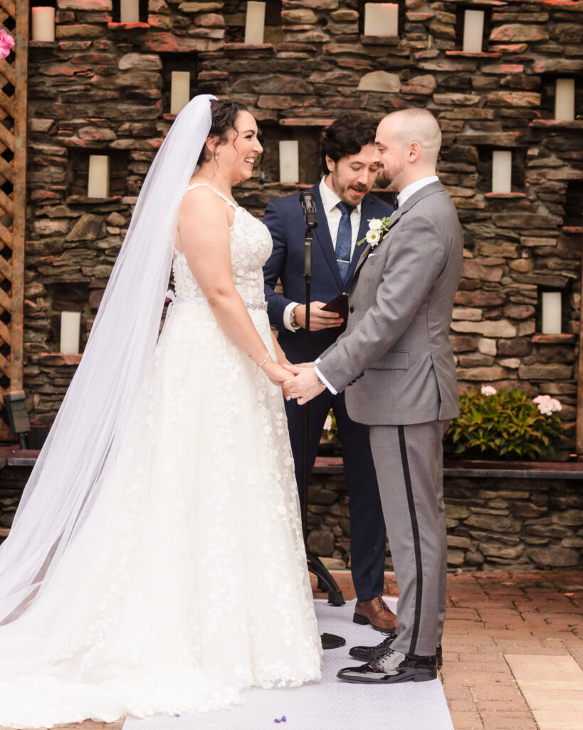 Bride and groom holding hands during the wedding ceremony at The Somerly.