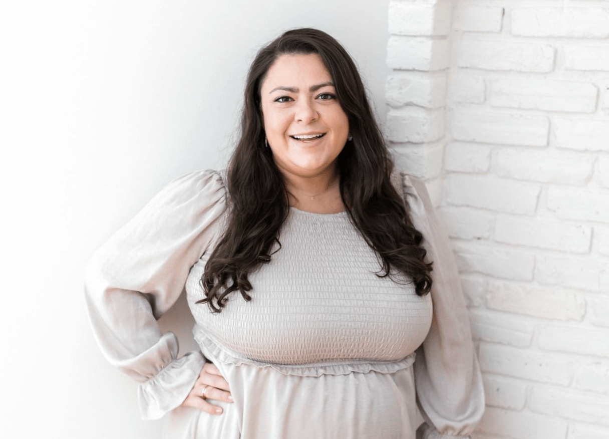 Wedding planner poses for professional headshots at her NYC office.