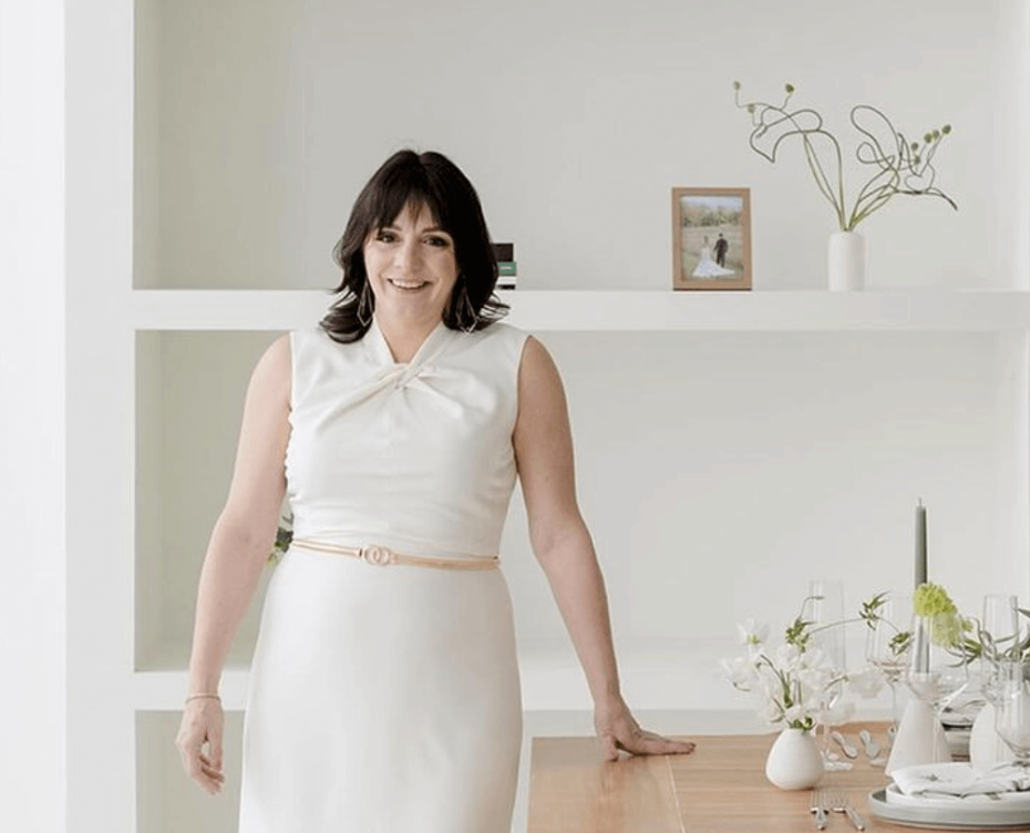 Wedding planner poses for professional headshot in her design office.