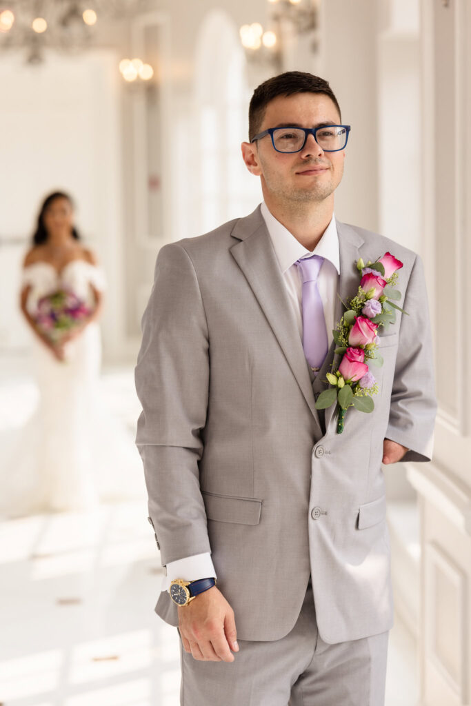 Groom with bride behind him right before the first look.