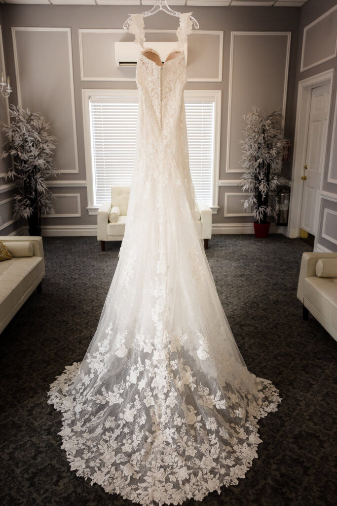 Bride's dress hanging in the middle of the bridal suite at The Coral House.