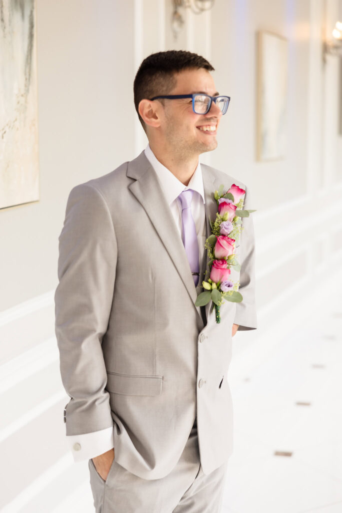 Groom smiling and looking to the side.