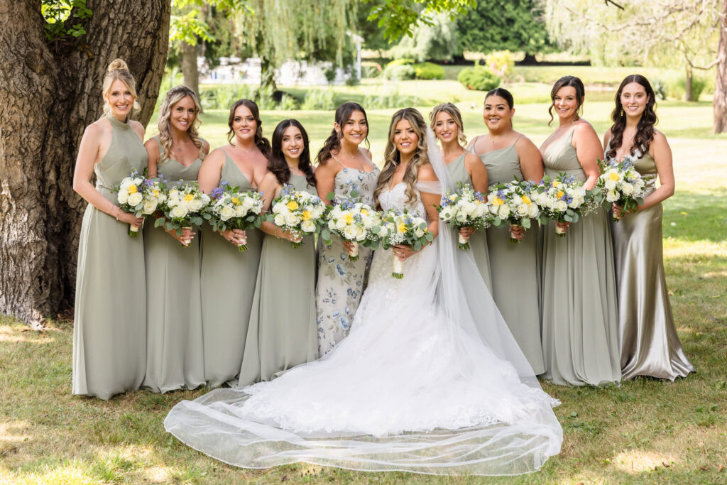 Bridesmaids and brides in formal posed picture at Flowerfield. 