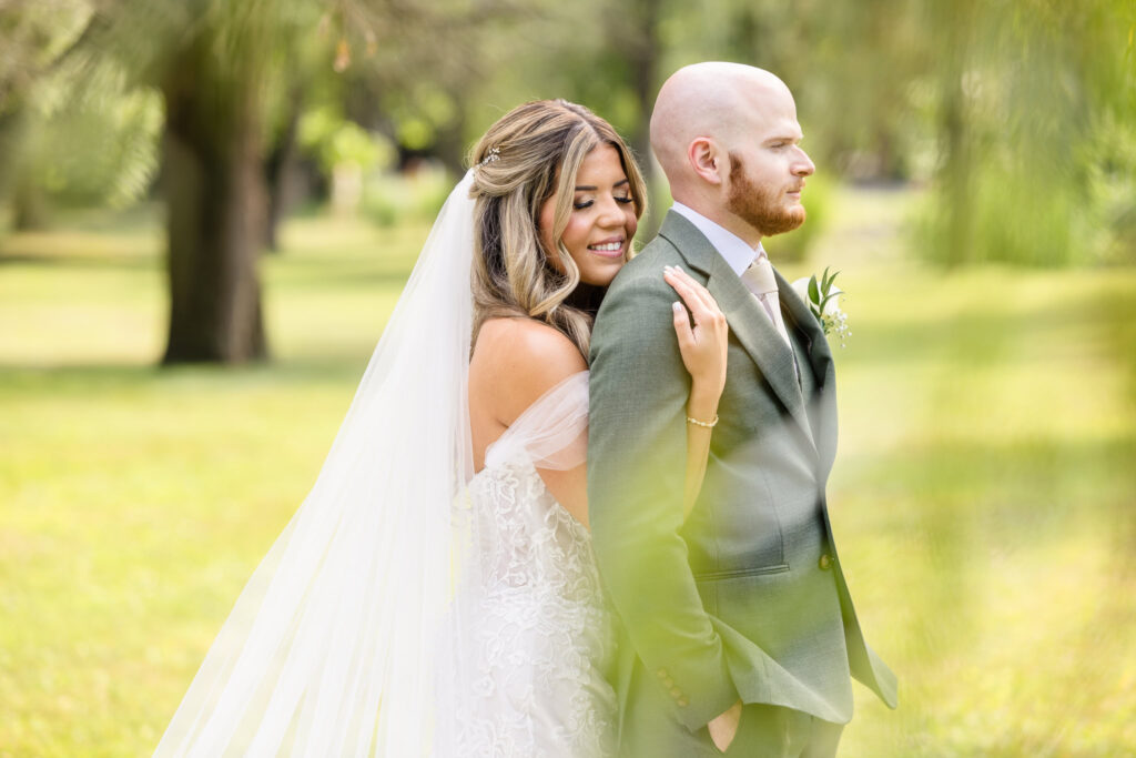 Bride hugging groom from behind at Flowerfield.