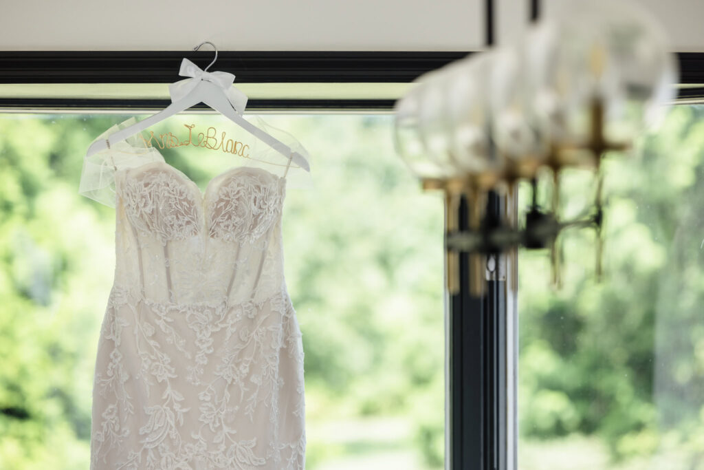 Wedding dress hanging in the window of Flowerfield cottage.