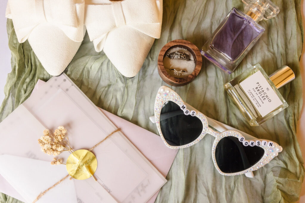 Shoes, glasses, invitation, rings, and perfume at Bates House.