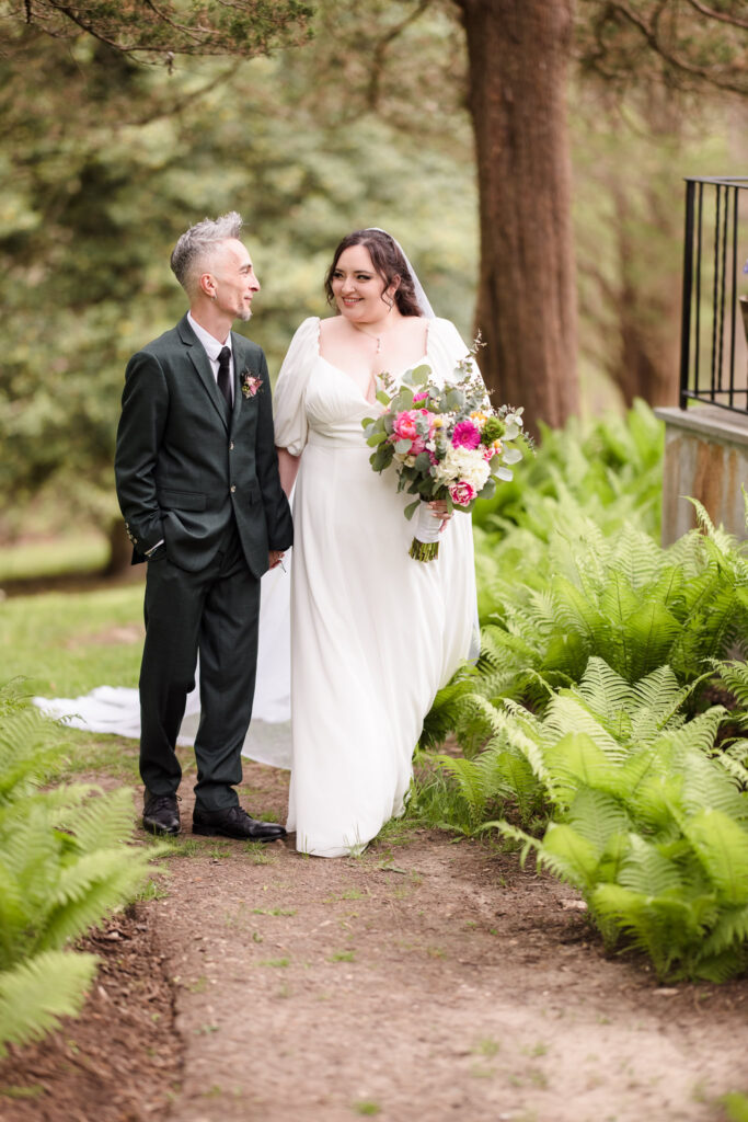 Bride and groom walking next to Bates House at Frank Memorial Park.