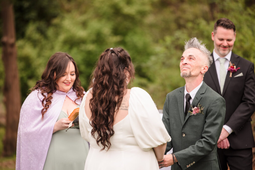 Groom holding back a tear during ceremony at Bates House.