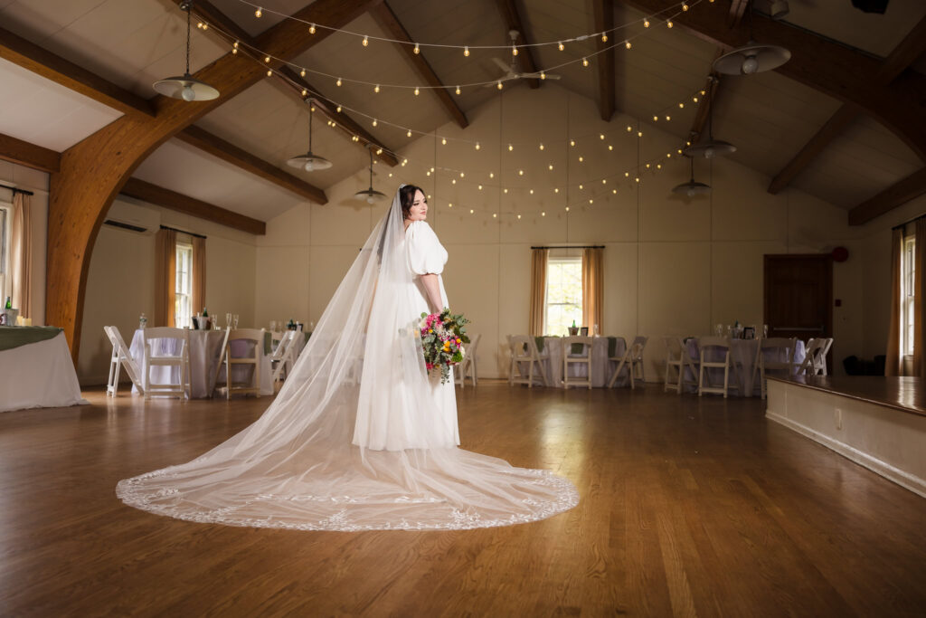 Bride standing in ballroom at Bates House at Frank Melville Park.