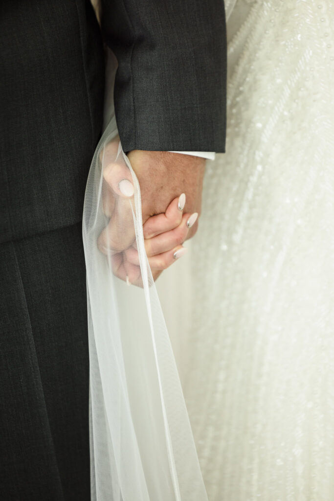 Bride and groom holding hands right before they see each other for the first time.