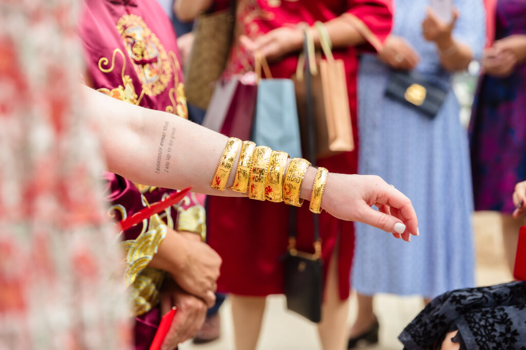 Bride's arm with six gold bracelets at Sand Castle. 