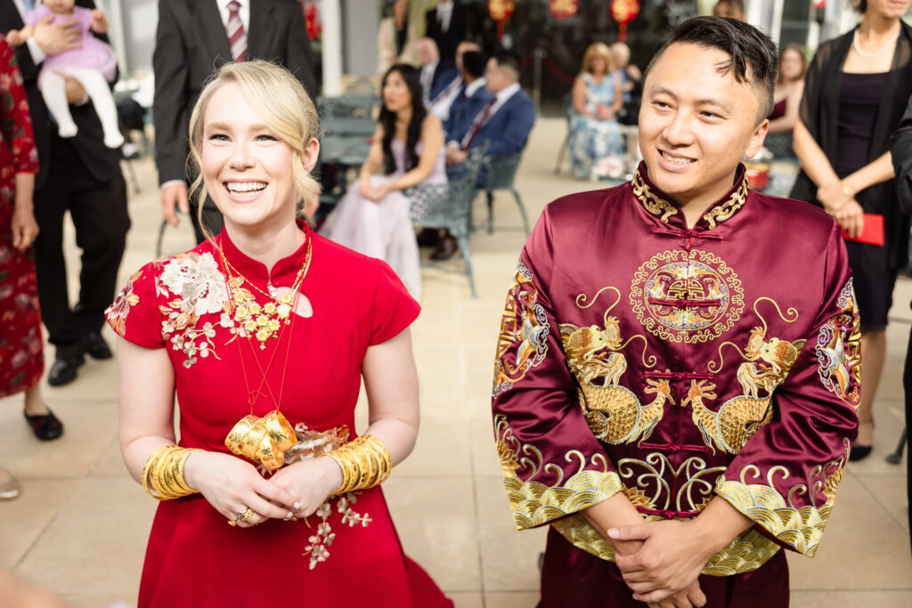 Bride and groom kneeling during Chinese Tea Ceremony at Sand Castle.