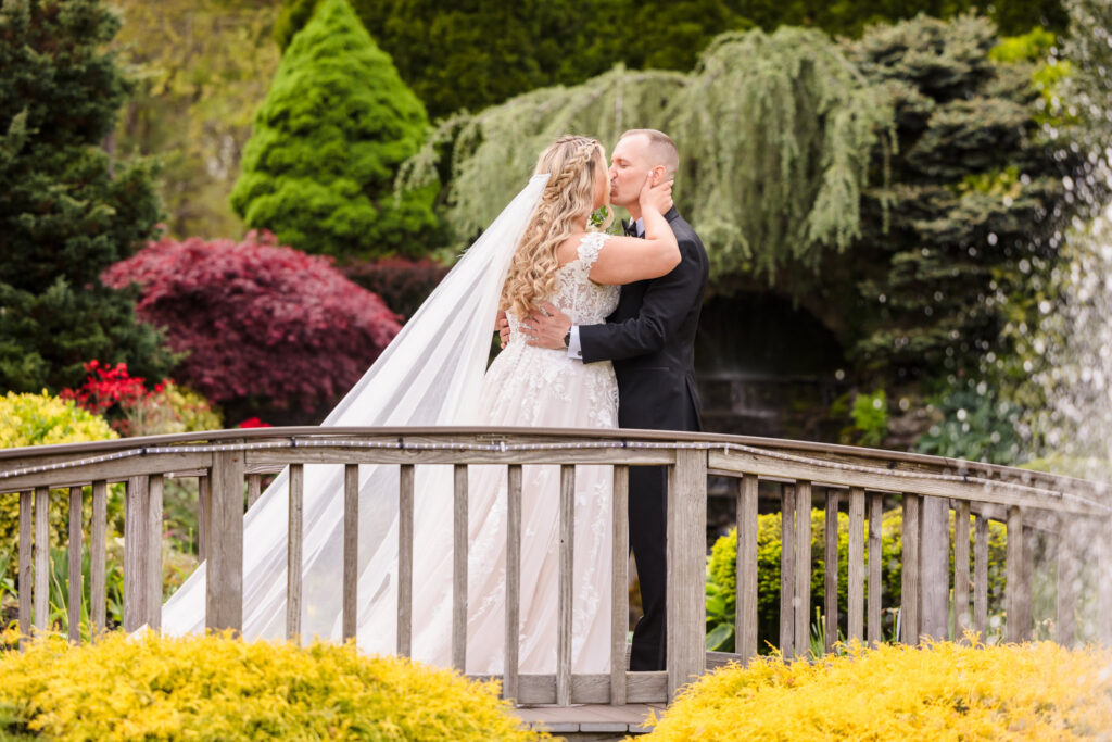 Bride and groom kissing on the bride at the Vineyard at East Wind Long Island. 